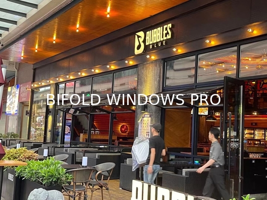 Slim-Profile Frameless Folding Window Illusion Creating Near-Invisible Transitions Between Interior and Deck Areas
